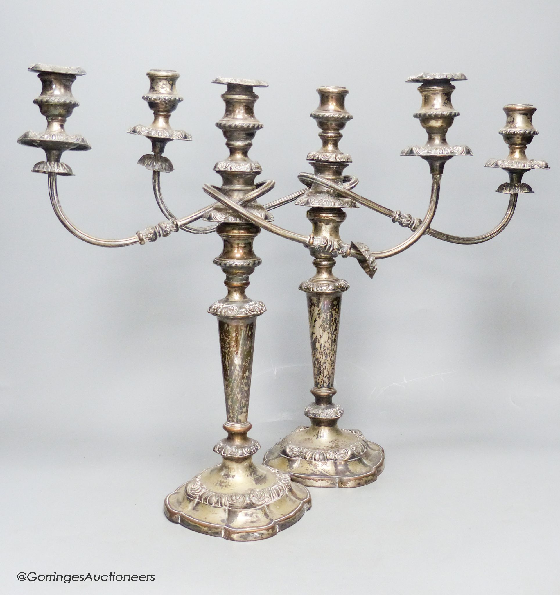 A pair of silver plated two branch three light candelabra, height 40cm
